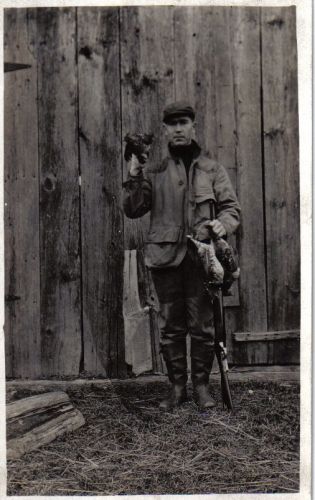 George Haire holding a live bird after hunting them