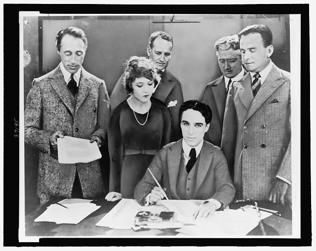 [D.W. Griffith, Mary Pickford, Charlie Chaplin (seated)...