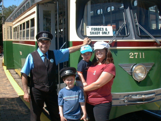 YOUNG FAMILY ENJOYS A RIDE ON THE "T" WITH "MR CONDUCTOR"