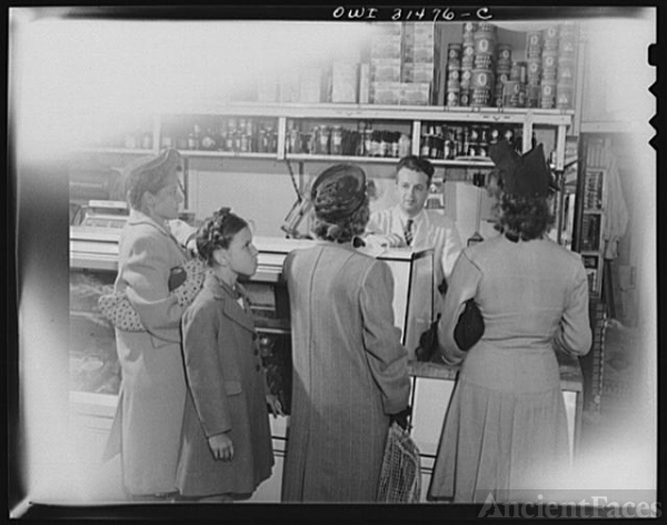Customers waiting for the butcher in a grocery store, in...