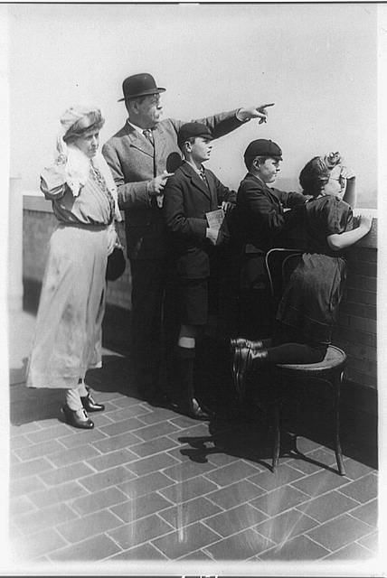 [Sir Arthur Conan Doyle and family looking over wall and...