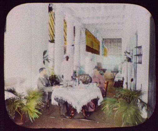 A wealthy Indian merchant's home; man and woman at dining...