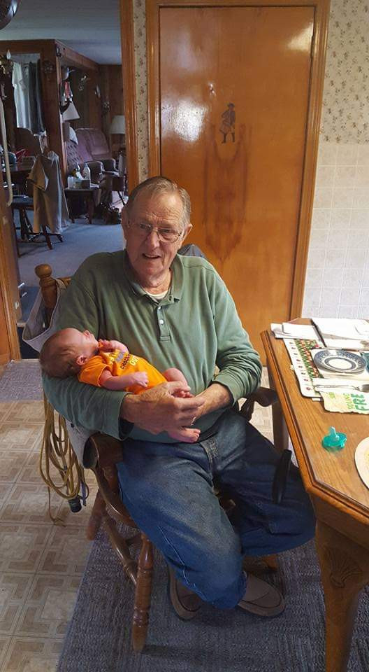 Dad holding great grandson kody
