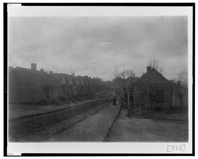 [Unpaved street with houses in Georgia]