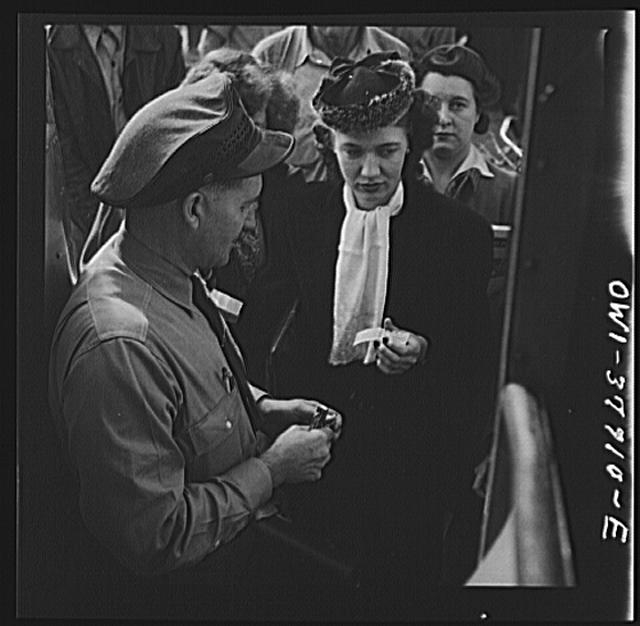 People boarding a Greyhound bus at a small town between...