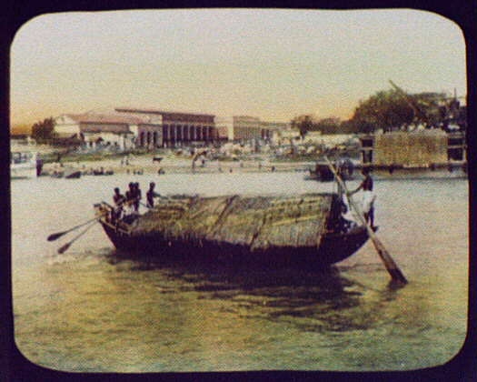 Calcutta - thatch-roofed boat in foreground; bathers and...