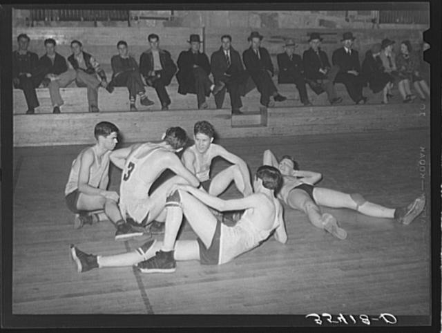 Basketball players resting between periods. Eufaula,...