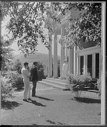 Schools. Two men carefully approaching a nurse standing...