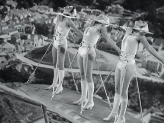 Busby Berkeley directing girls on airplanes.