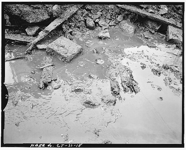 18. DETAIL VIEW OF TIMBER FOUNDATION FOOTINGS, LOOKING...