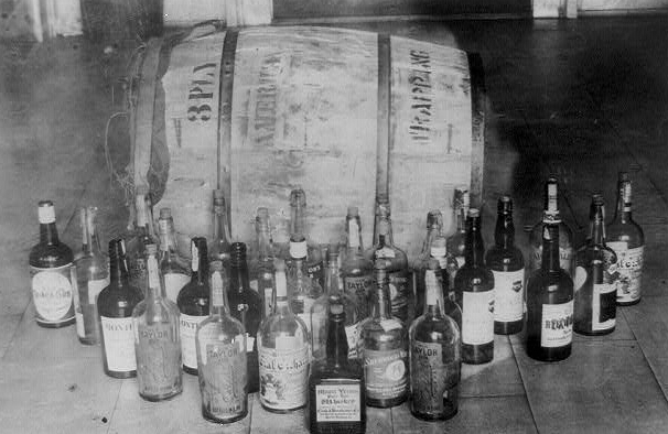 Bottles and barrel of confiscated whiskey