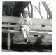 little girl sitting on a park bench