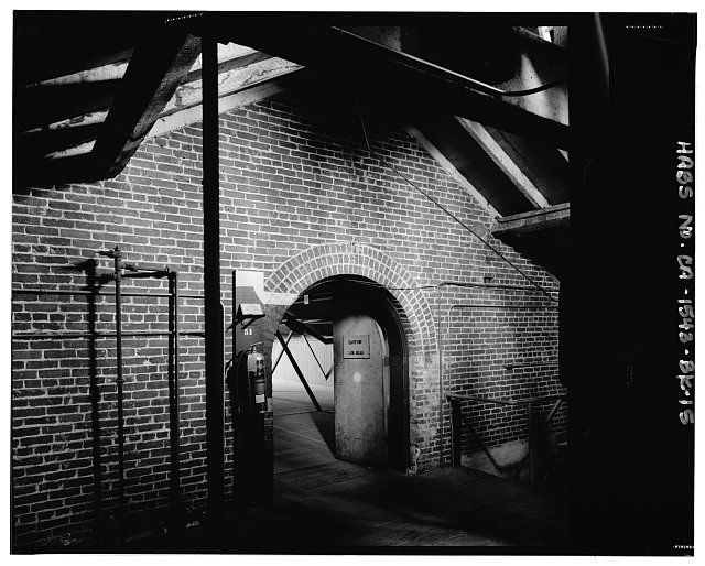 Interior detail of attic space showing wall with brick...