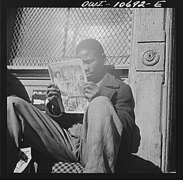 Washington, D.C. Negro youth reading a funny paper on a...