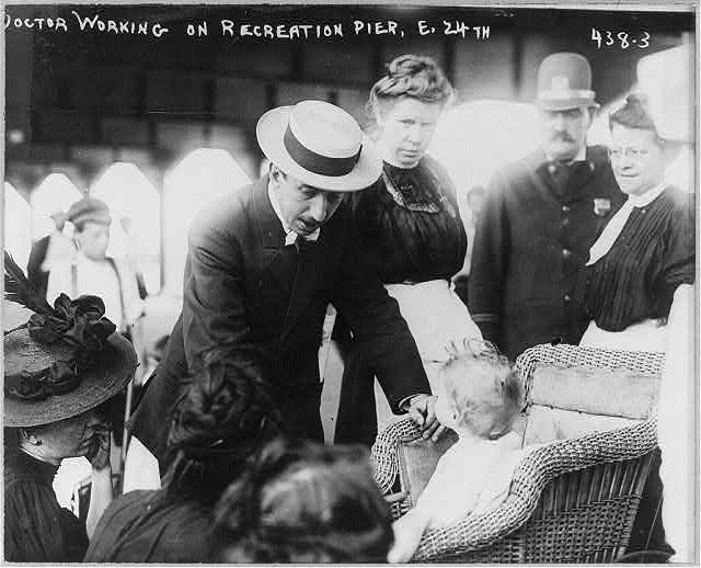 Babies and child care - doctor examining babies on...