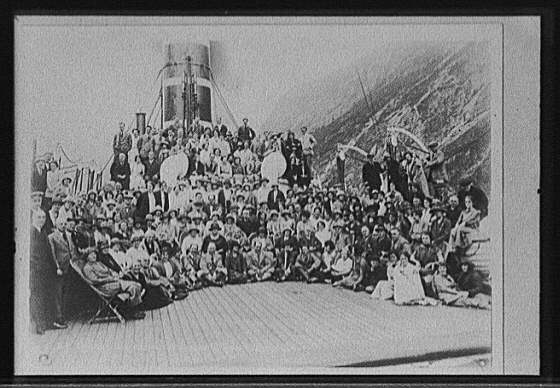 [Passengers posed on deck of steamship in passage with...