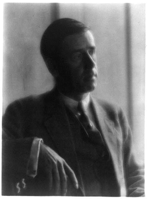 [Clarence White in suit, seated]