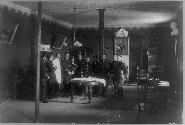 [Mexican military officers standing around a table in a...