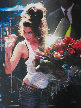 Amy Winehouse performing and receiving flowers
