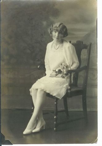 Lady in White dress holding flowers