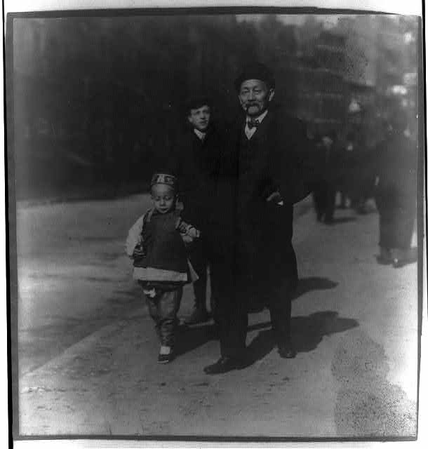 [Chinese-American man walking with son, Chinatown, New...