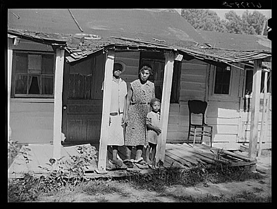 Mrs. Calip White and two of her children on front porch...
