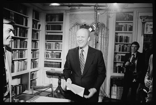 [President Gerald Ford standing and smiling after giving...
