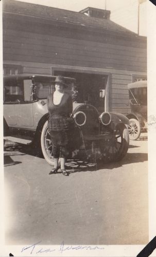 Woman in front of antique car