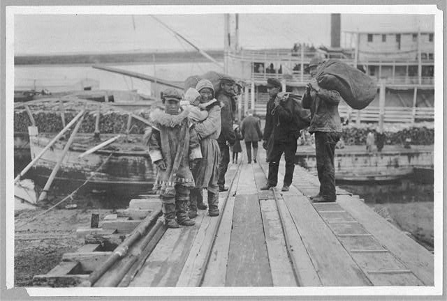 [Eskimos on a dock]