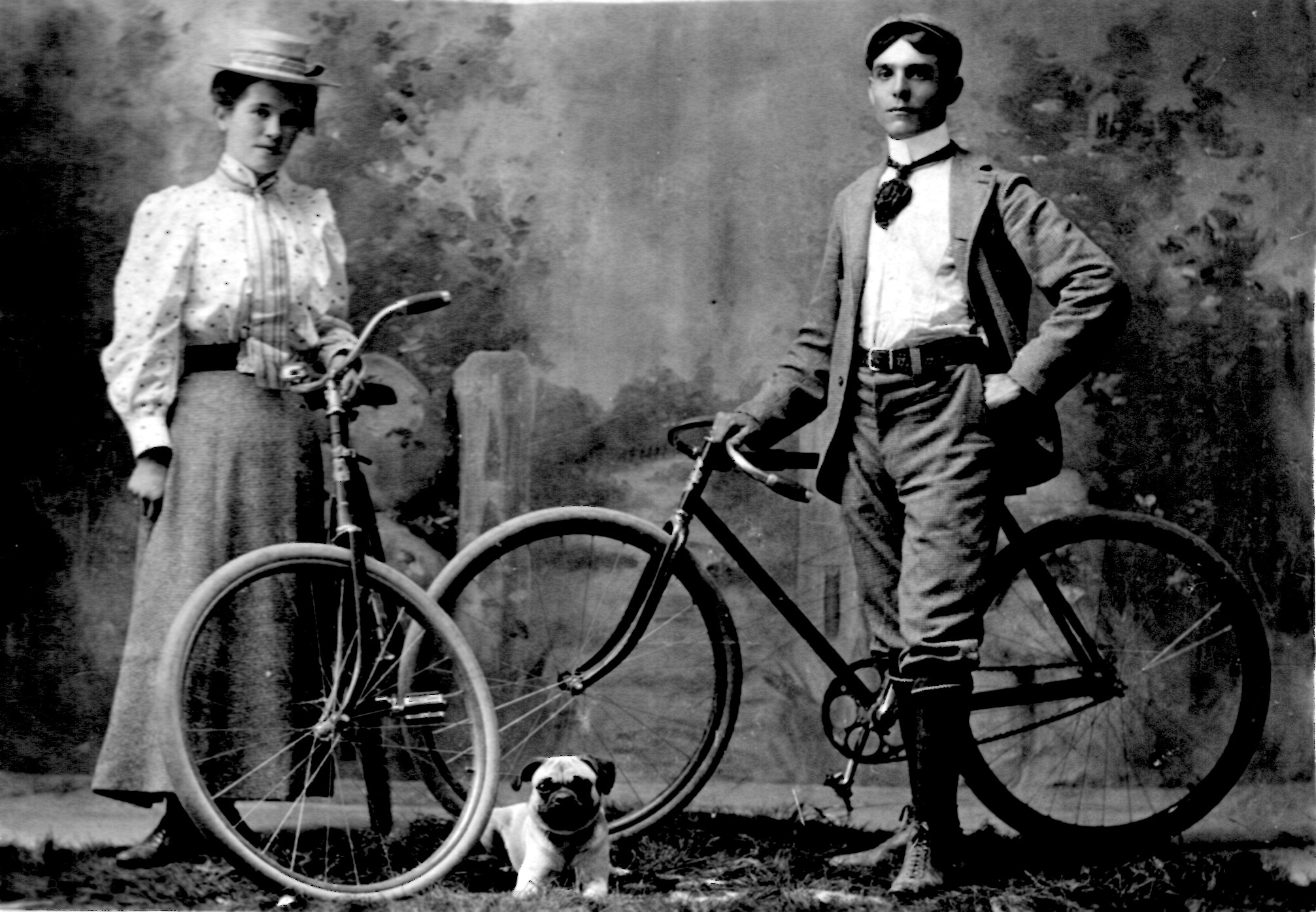 Young couple on bikes, 1900