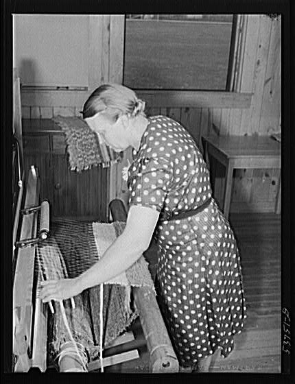 Mrs. Lloyd Young weaving a rug at Plum Bayou Project,...