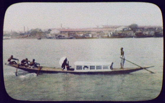 Calcutta - 3 oarsmen pulling long, narrow passenger boat