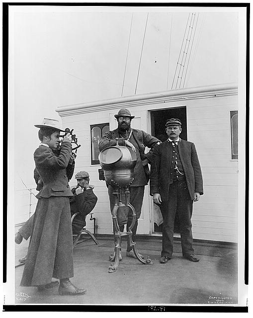 [Woman looking through sextant on board the expedition...