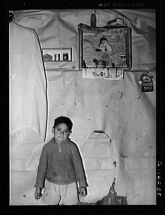 Mexican boy living in corral, Robstown, Texas. Notice the...