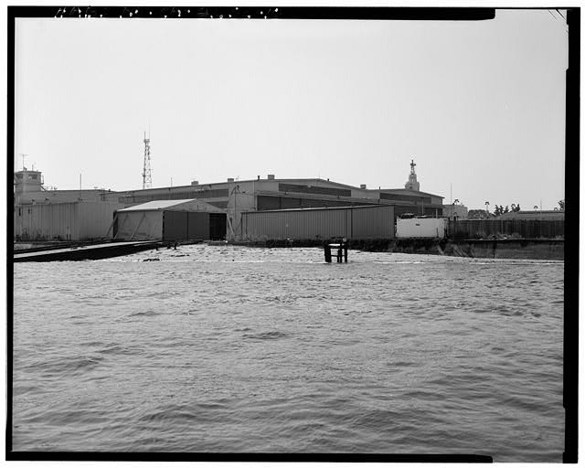 View southeast toward building 68. Building 68 partially...
