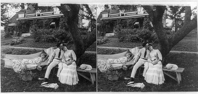 [Man with arm around woman on bench and chaperone...