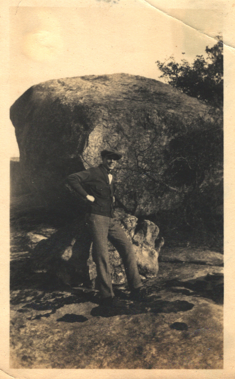 Man in front of a large rock