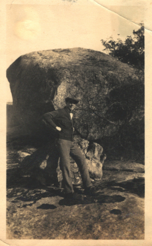 Man in front of a large rock Man in front of a large rock