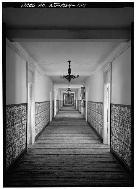 104. VIEW DOWN A TYPICAL CORRIDOR ON AN UPPER FLOOR OF A...