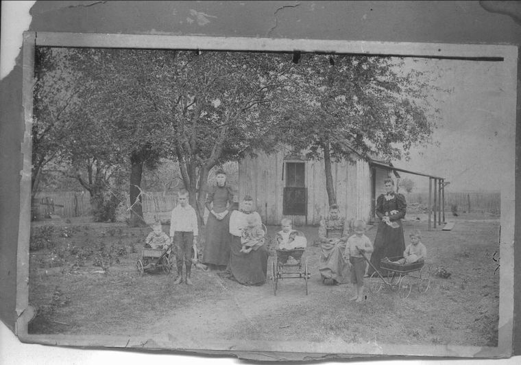 women and Children in front of house