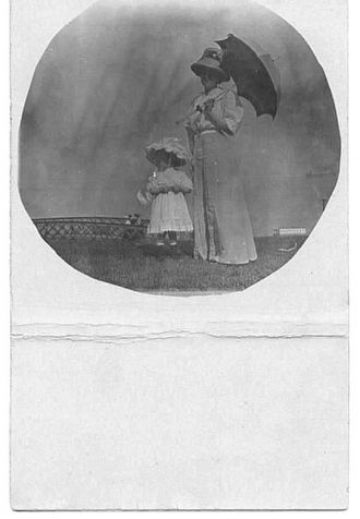 Lady with umbrella and child
