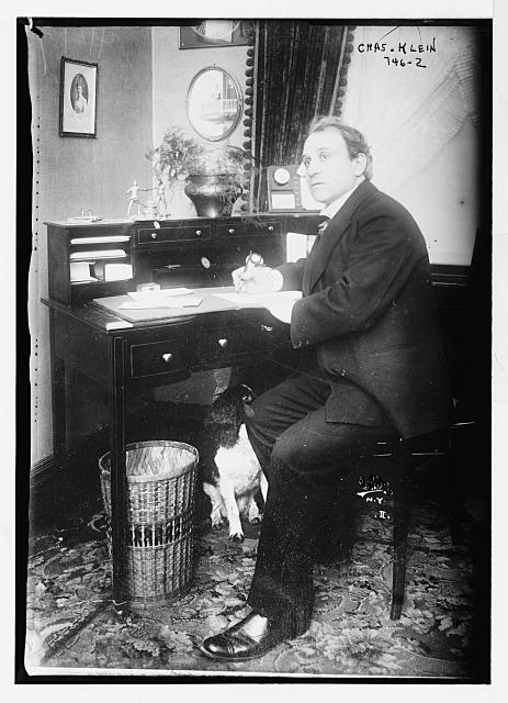 Chas. Klein, writing, at desk