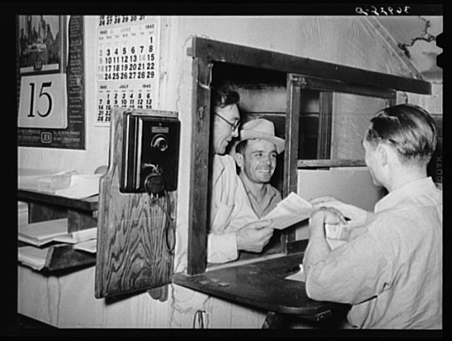 Workers at mine receiving paychecks. Mogollon, New Mexico