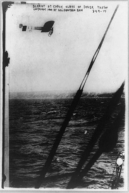 [Louis Blériot in his plane over the cliff of Dover,...