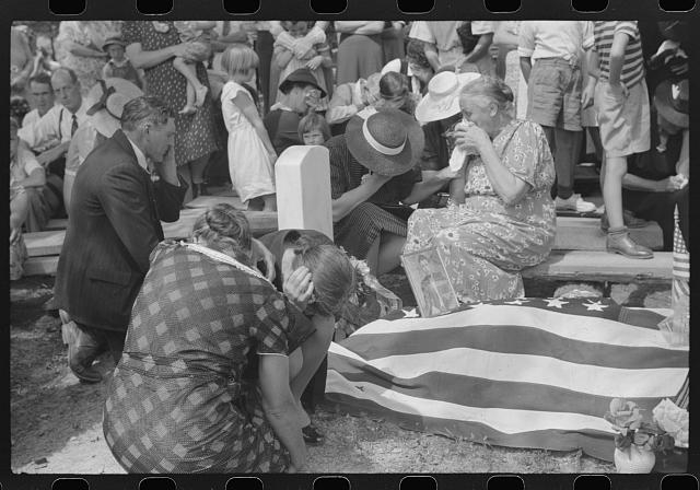 Mother and widow and relatives weeping at the grave of...