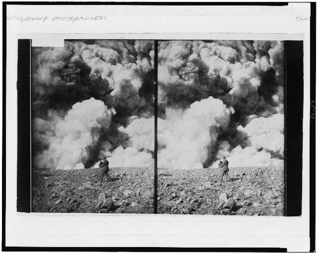 [Man holding large camera photographing a cataclysmic...