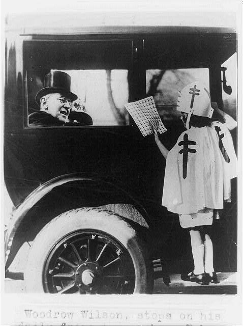 Woodrow Wilson stops on his daily drive to purchase...