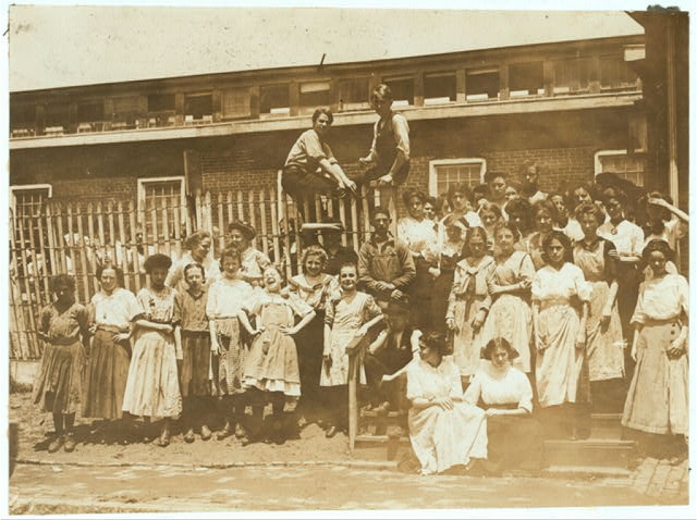 [Groups of girls workers at the gate of the American...