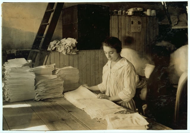 15-year old girl folding towels in Bonanno Laundry....