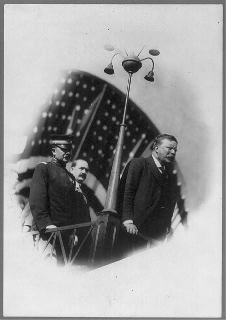 [Theodore Roosevelt standing on platform]